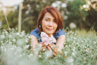 Portrait of woman resting on field