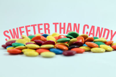 Close-up of multi colored candies against white background