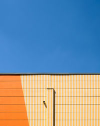 Low angle view of building against clear blue sky