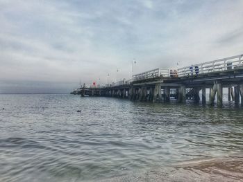 Bridge over sea against sky