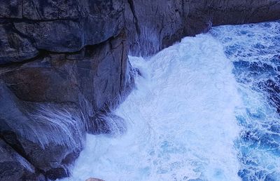 Scenic view of river flowing through cave