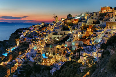 High angle view of townscape by sea against sky