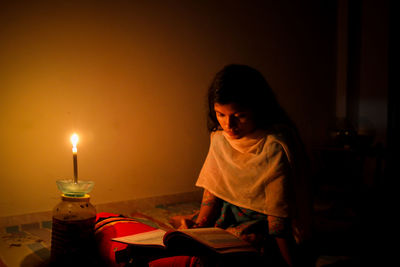 Girl sitting on table at home