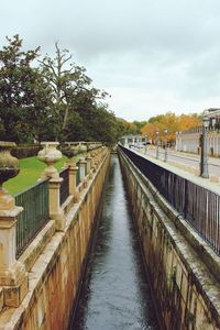 Bridge over canal against sky