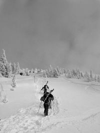 Man on snowy field against sky