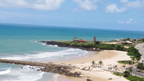 Scenic view of beach against cloudy sky