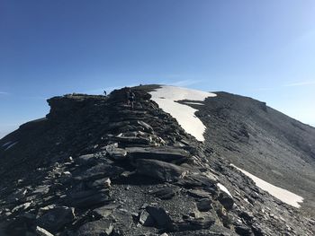 Rock formations against clear blue sky