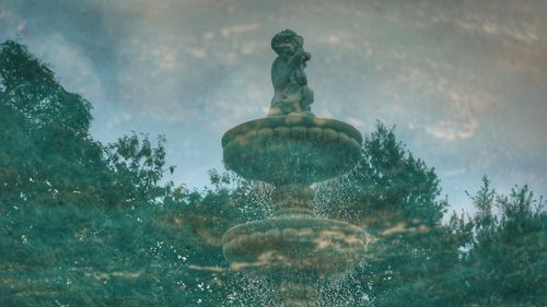 Low angle view of statue against fountain