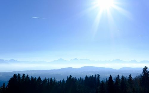 Scenic view of mountains against blue sky