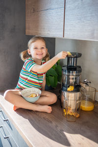 Portrait of cute girl sitting on table