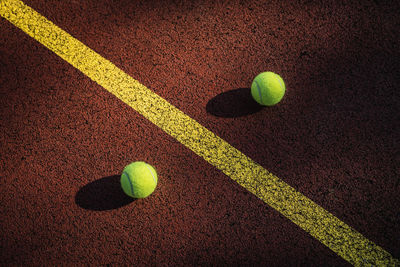 High angle view of tennis balls on field