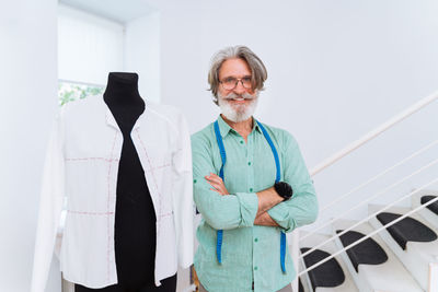 Portrait of smiling fashion designer at boutique