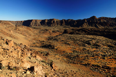 Rocky mountains at el teide national park against clear blue sky