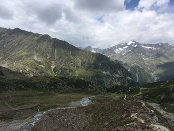 Scenic view of mountains against cloudy sky