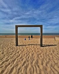 People on beach against sky