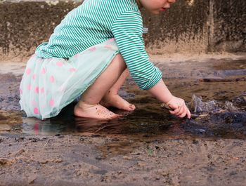 Low angle view of woman playing in water