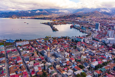 High angle view of city buildings by sea