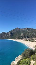 Scenic view of mountains against clear blue sky