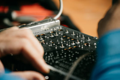 Cropped hands of man repairing laptop