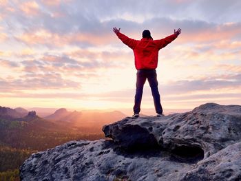 Male hiker walking on top of mountain looking at beauty morning landscape. man hiking silhouette