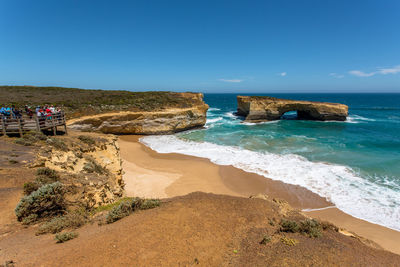 Scenic view of beach against blue sky