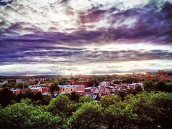 Cityscape against cloudy sky