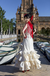 Portrait of young woman in traditional clothes standing outdoors