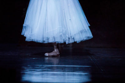 Low section of ballerina performing on stage in theater