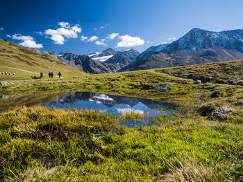 Scenic view of landscape and mountains against blue sky