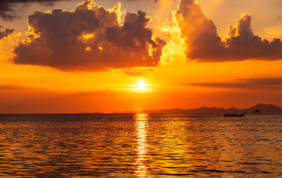 Scenic view of sea against orange sky