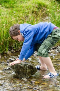 Rear view of boy in water
