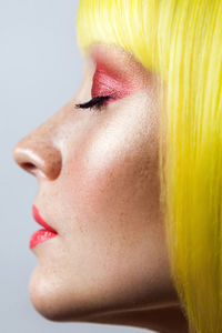 Close-up portrait of young woman over white background