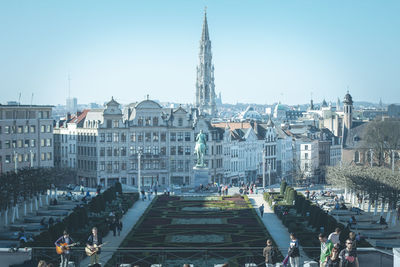 People in city against clear sky