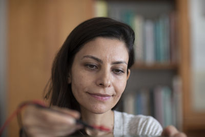 Student female with tools in a library doing a try