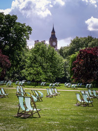 Chairs on grass against trees