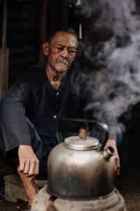 Portrait of senior man working in workshop