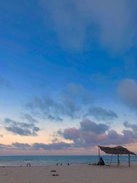 Scenic view of beach against sky during sunset