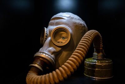 Close-up of machine on table against black background