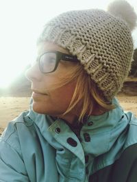 Close-up portrait of young woman with ice cream in sand