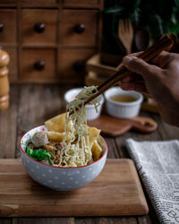Midsection of person having food on table