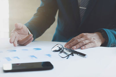 Close-up of woman holding hands on table