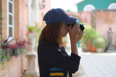 Woman photographing in city