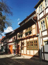Houses by street against sky in city