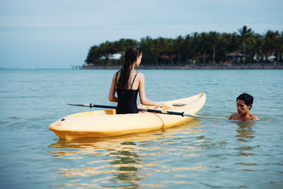 Man kayaking in sea