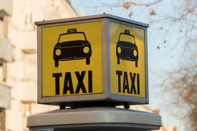 Close-up of taxi sign in city