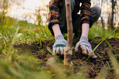 Low section of woman standing on field