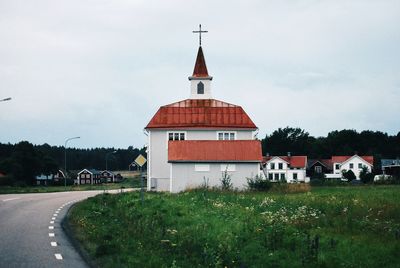 Road by building against sky in city