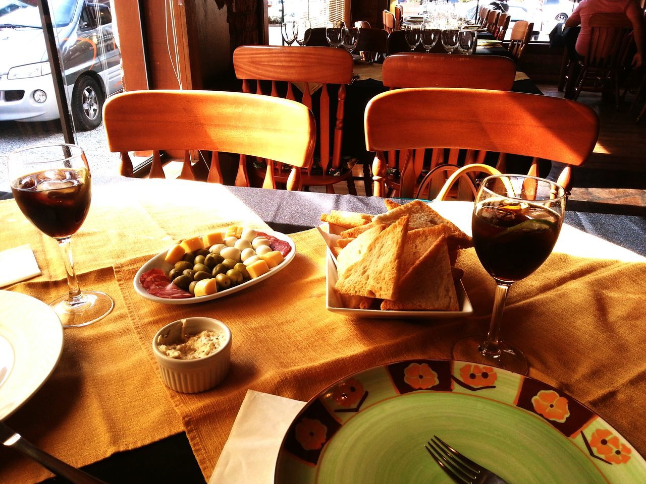 table, drink, indoors, chair, food and drink, coffee cup, coffee - drink, restaurant, refreshment, place setting, cafe, saucer, dining table, plate, still life, absence, freshness, wood - material, sidewalk cafe, drinking glass