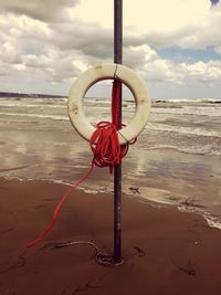 Rope on beach against sky