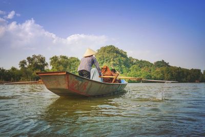 Boat in lake against sky